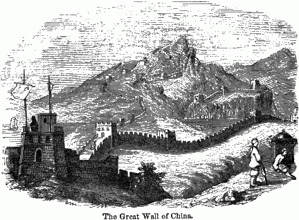 The Great Wall of China. A long shot of part of the Great Wall with some men in the foreground.