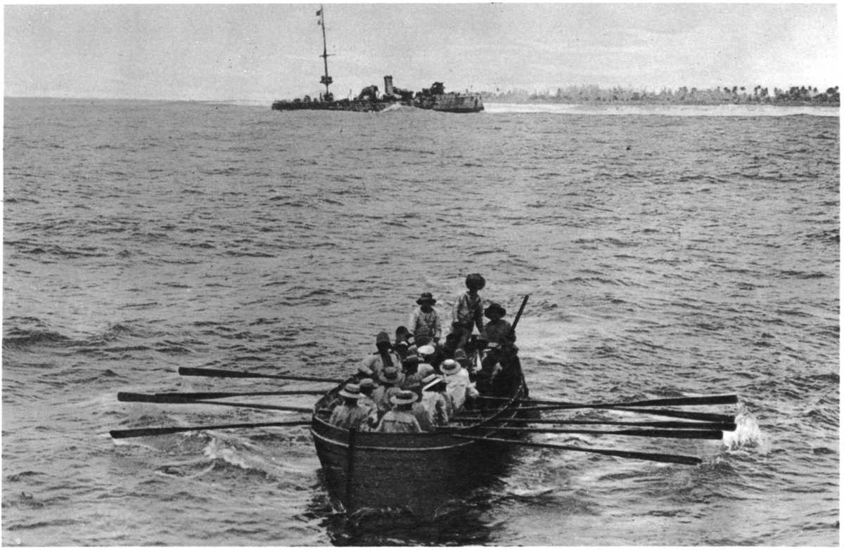 "DRIVEN ASHORE AND BURNT": THE "EMDEN" BEACHED ON NORTH KEELING ISLAND, AND A BOATLOAD OF PRISONERS COMING AWAY.