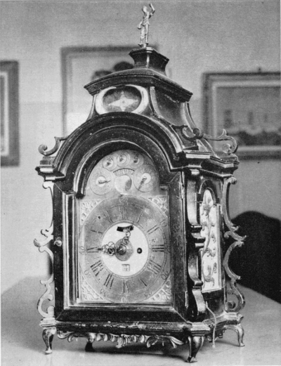 Figure 29. Figure 29.—Table clock by Bertolla in the collection of Doctor Vittorio dal Lago of Bergamo. The dial indicates the days of the week and of the month, the names of the months and lunar phases. The clock strikes the hours and quarters and repeats. (Courtesy of Sig. Luigi Pippa of Milan.)